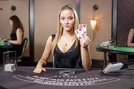 Mobile app interface showing live blackjack table with dealer and betting controls